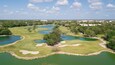 Golf course with gorgeous green and pond. Aerial view of a beautiful green golf course