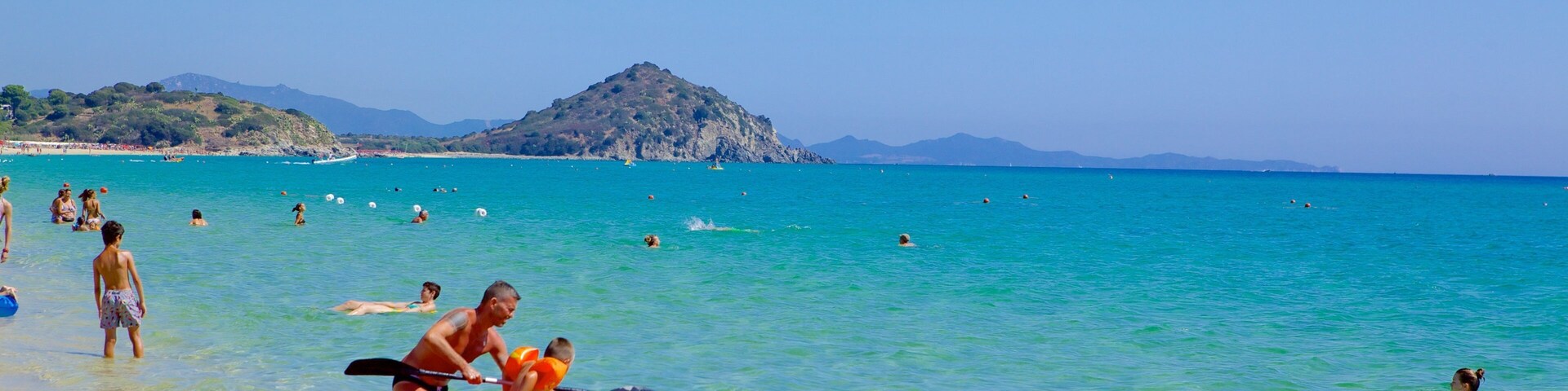 Cala Sinzias featuring a beach and kayaking or canoeing
