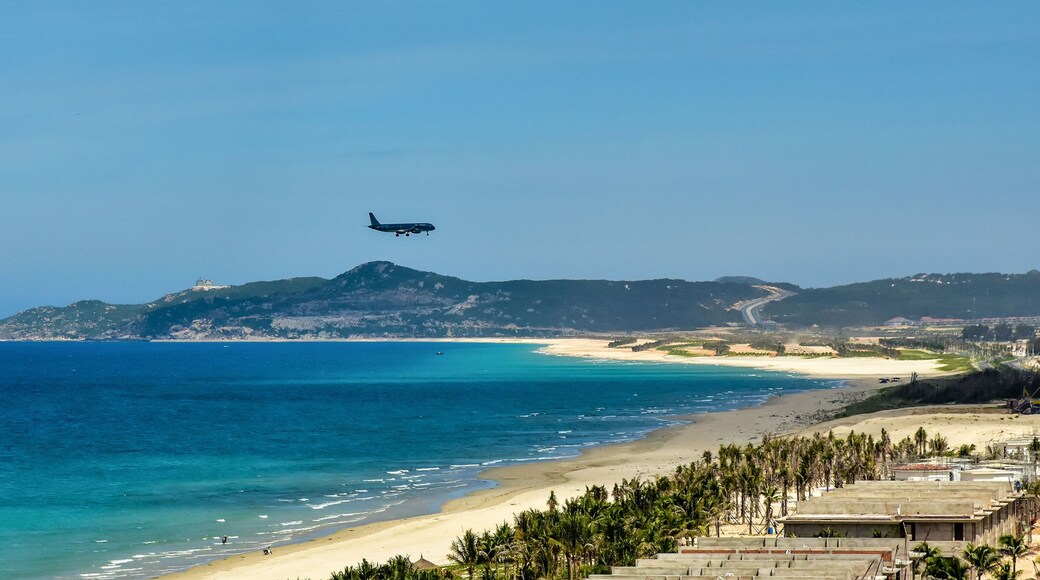 Cam Rahn. Vietnam. The plane flies over the road and the beach and landing at the airport