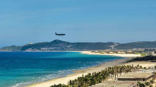 Cam Rahn. Vietnam. The plane flies over the road and the beach and landing at the airport