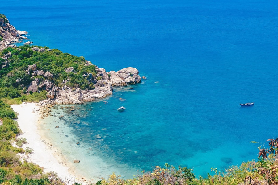 Beautiful tropical beach of Binh Ba, the paradise island with the coast, white sand, clean water, boat, and blue sky. Binh Ba island is a popular tourist destination in Cam Ranh, Nha Trang, Vietnam
