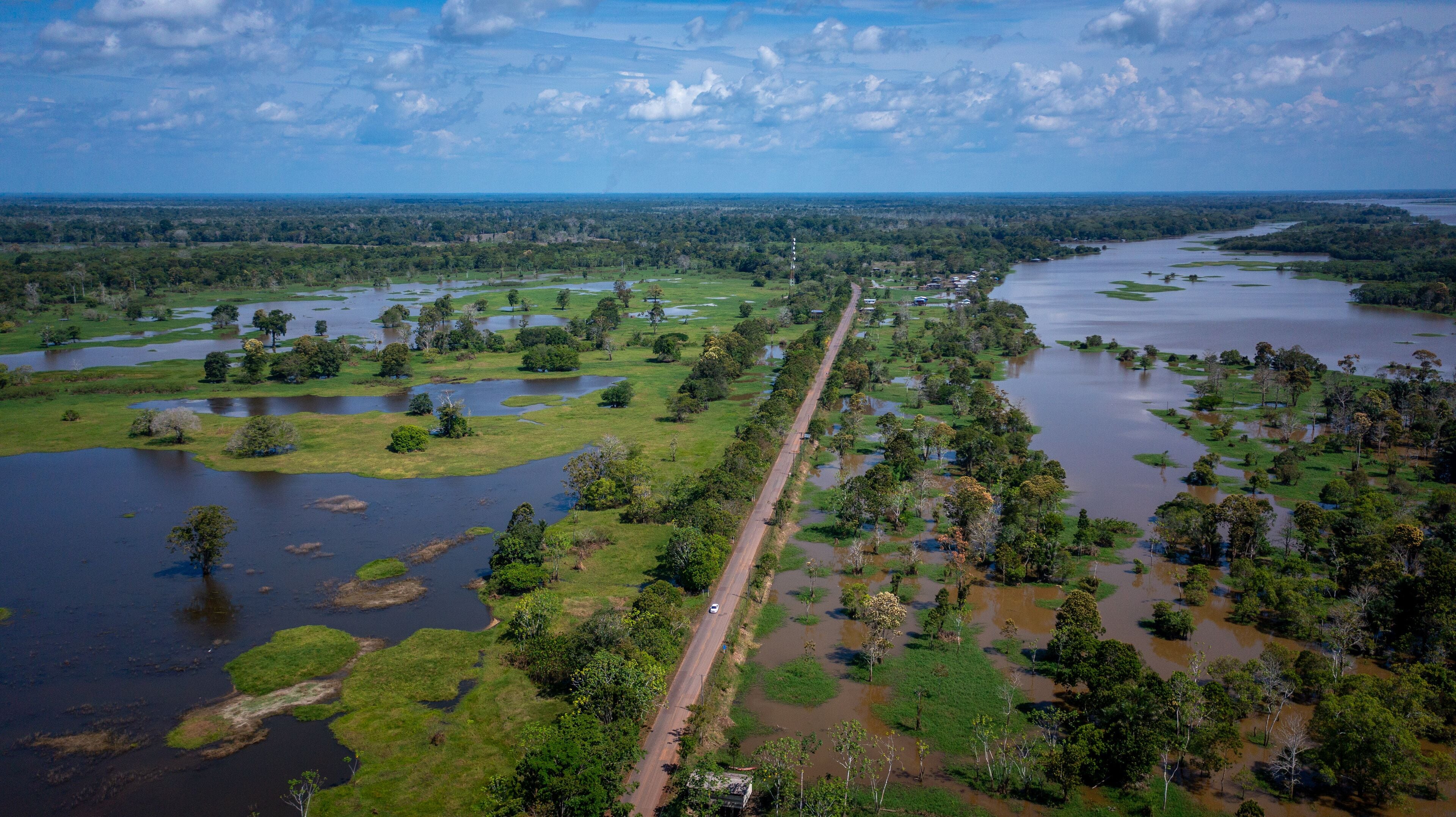 Aerial view of the BR 319 highway linking Manaus and Porto Velho in the Brazilian Amazon. The beginning of the route in Careiro da Várzea is surrounded by wetlands and rainforest. Amazonas, Brazil