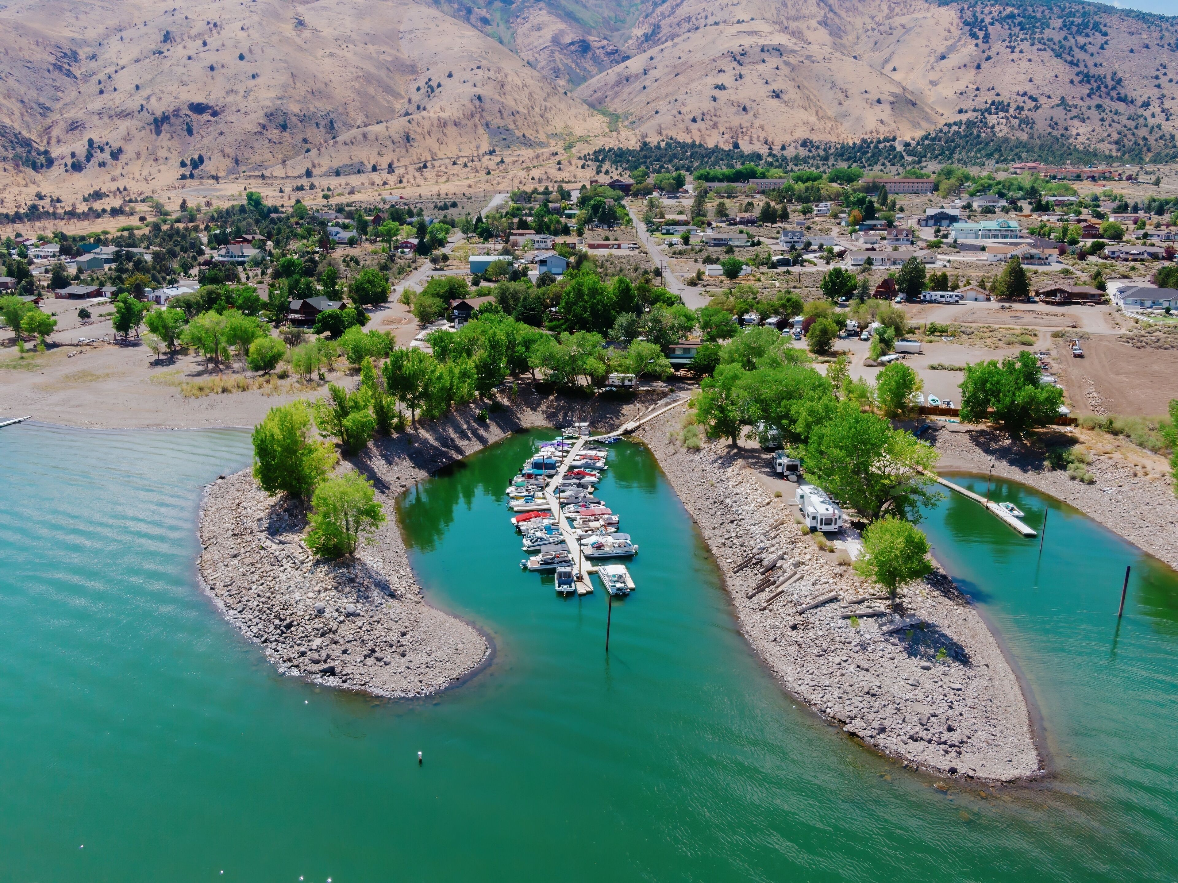 Aerial view of boats docked at a marina on Topaz Lake in the Nevada, United States. Mountains and a small town are visible in the background. Recreation and tourism.