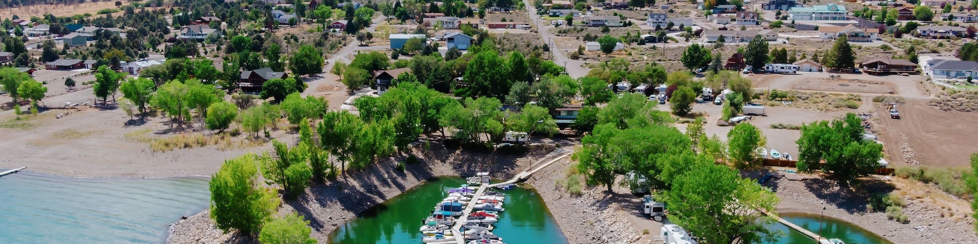 Aerial view of boats docked at a marina on Topaz Lake in the Nevada, United States. Mountains and a small town are visible in the background. Recreation and tourism.
