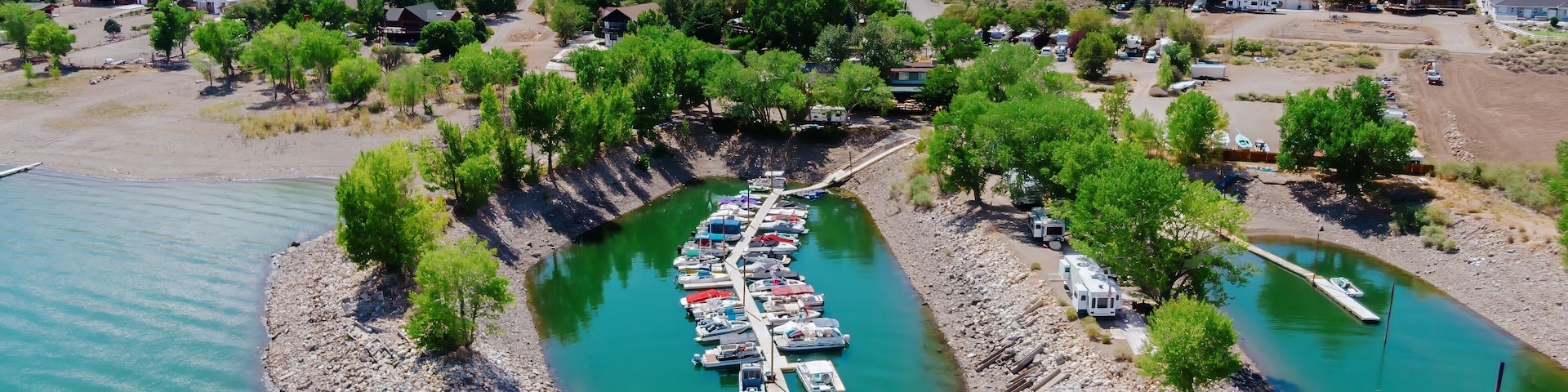 Aerial view of boats docked at a marina on Topaz Lake in the Nevada, United States. Mountains and a small town are visible in the background. Recreation and tourism.