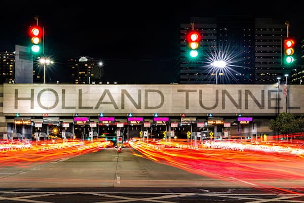 Holland Tunnel toll booth by night. The Holland Tunnel is a highway tunnel under the Hudson River between New York and Jersey City