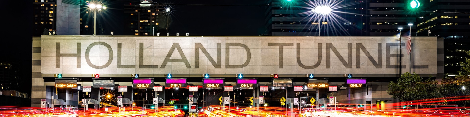 Holland Tunnel toll booth by night. The Holland Tunnel is a highway tunnel under the Hudson River between New York and Jersey City