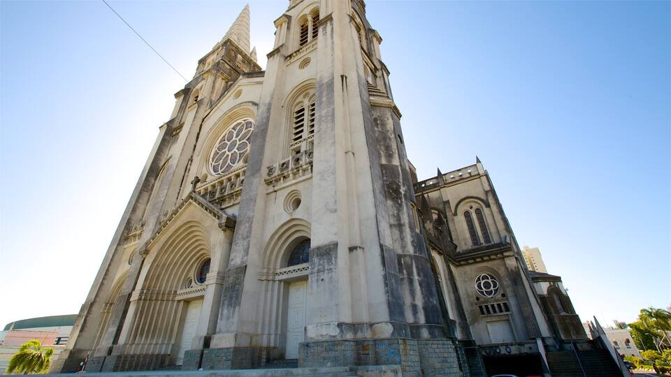 A large, historic church with a tall bell tower and large stained glass windows.