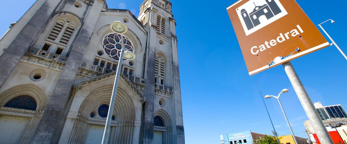A cathedral with a tall spire and a large circular stained glass window.