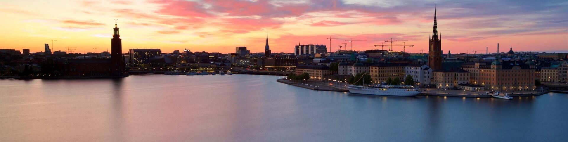 Monteliusvagen showing a sunset, landscape views and a city