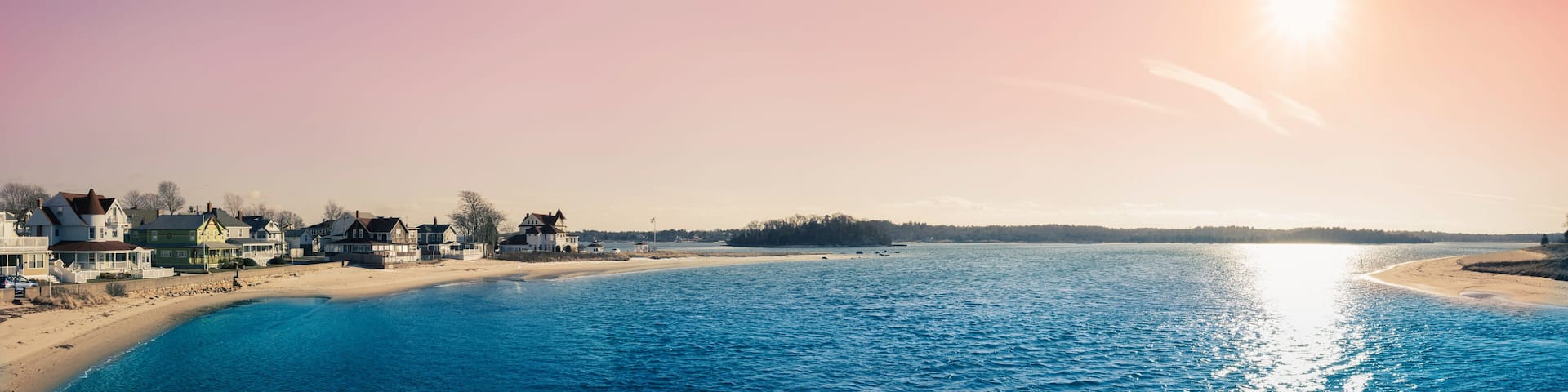 A coastal town with houses along the beach and a clear view of the ocean.