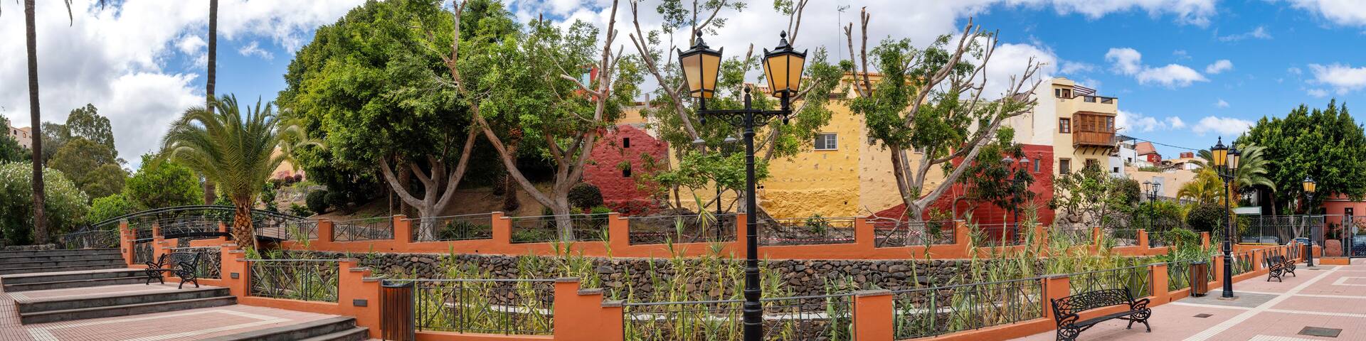 Historic houses and plant landscape in Ingenio seen from the peaceful Parque Nestor Alamo on the island of Gran Canaria.