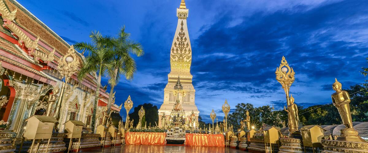 A temple with a tall spire, golden statues, and a checkered floor.