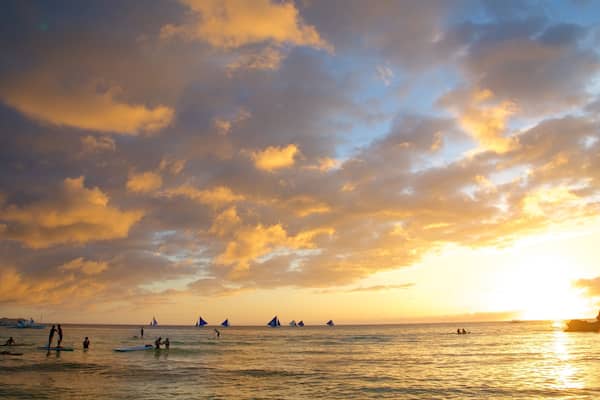 White Beach featuring island images, a sunset and kayaking or canoeing
