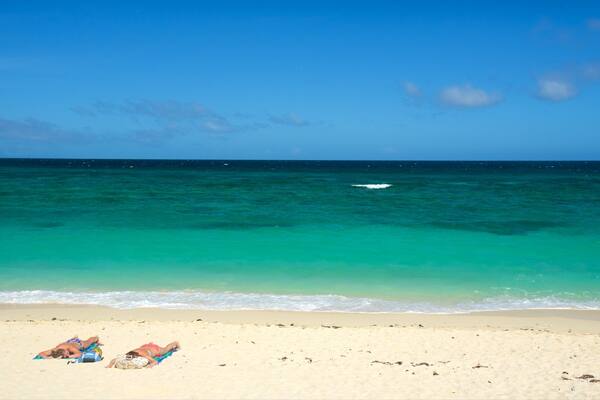 Ilig-Iligan Beach showing tropical scenes and a beach as well as a couple