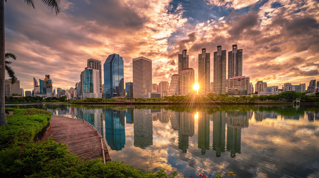 Cityscape image of Benchakitti Park at sunrise in Bangkok, Thailand.