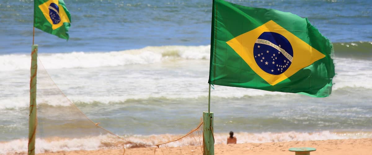 salvador, bahia, brazil - january 6, 2021: Brrazil\'s flag is seen on a mast on Armacao beach in the city of Salvador