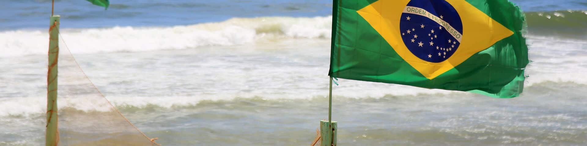 salvador, bahia, brazil - january 6, 2021: Brrazil\'s flag is seen on a mast on Armacao beach in the city of Salvador