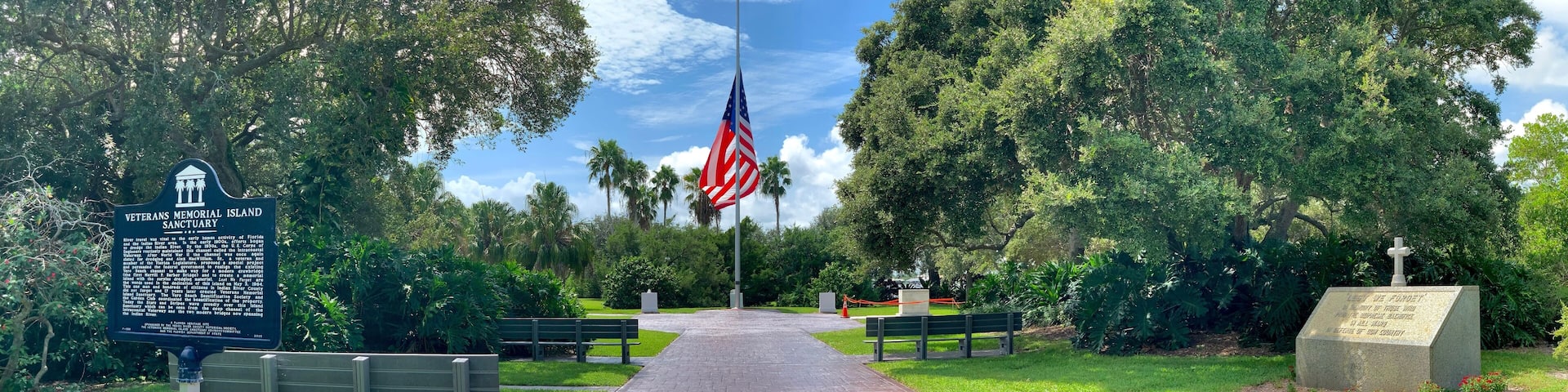 Large American Flag flying at half mast at Veterans Memorial State Park in Vero Beach, Florida.