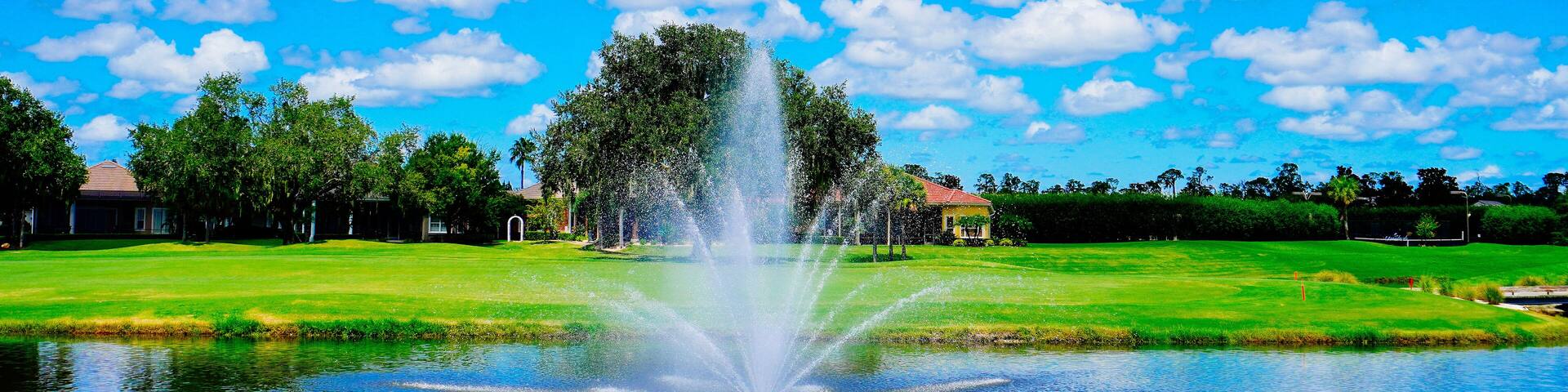 Florida blue sky, lake, fountain and house