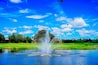 Florida blue sky, lake, fountain and house