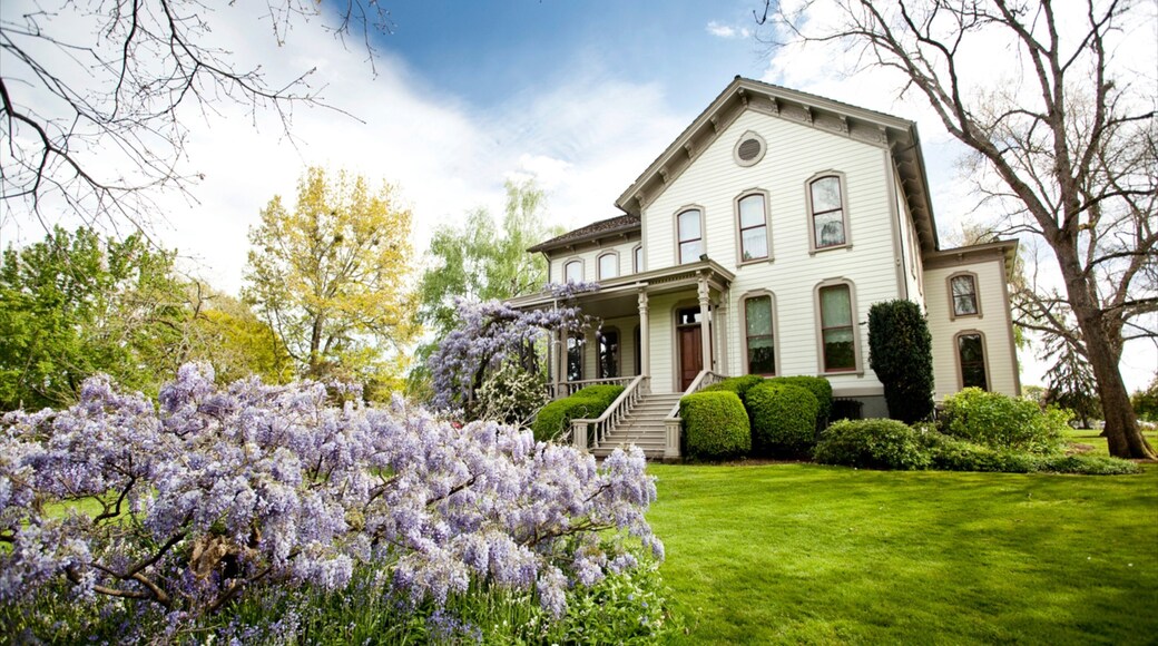 Bush House Museum featuring flowers and a house