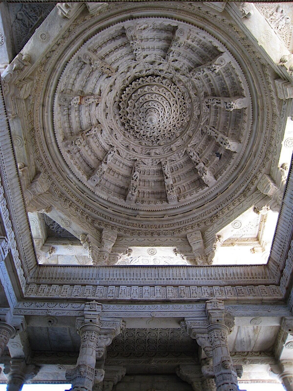 A detailed stone ceiling with a circular pattern and ornate carvings.