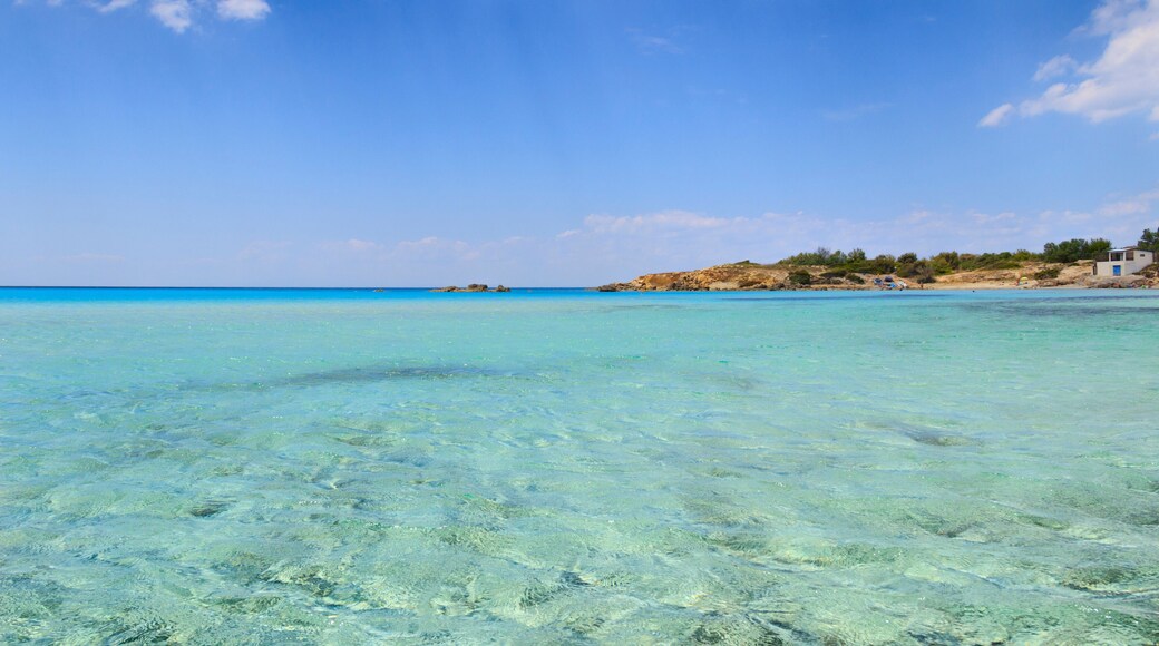 Summer seascape,Apulia coast: Marina di Pulsano beach (Taranto). The coastline is characterized by a alternation of sandy coves and jagged cliffs overlooking a truly clear and crystalline sea (Italy).