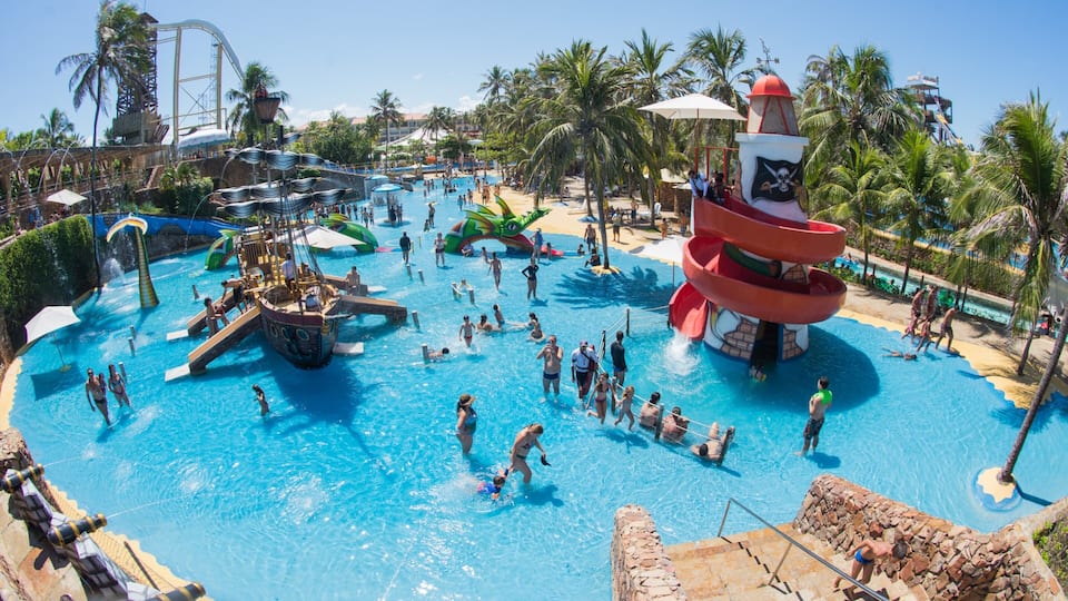 Beach Park Water Park which includes swimming and a waterpark as well as a large group of people