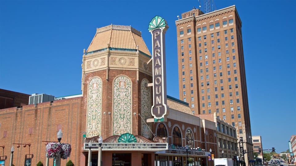 A historic theater with ornate architecture and a tall building in the background.