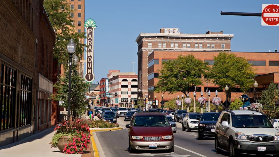 A busy urban street with cars, buildings, and a 'Do Not Enter' sign.