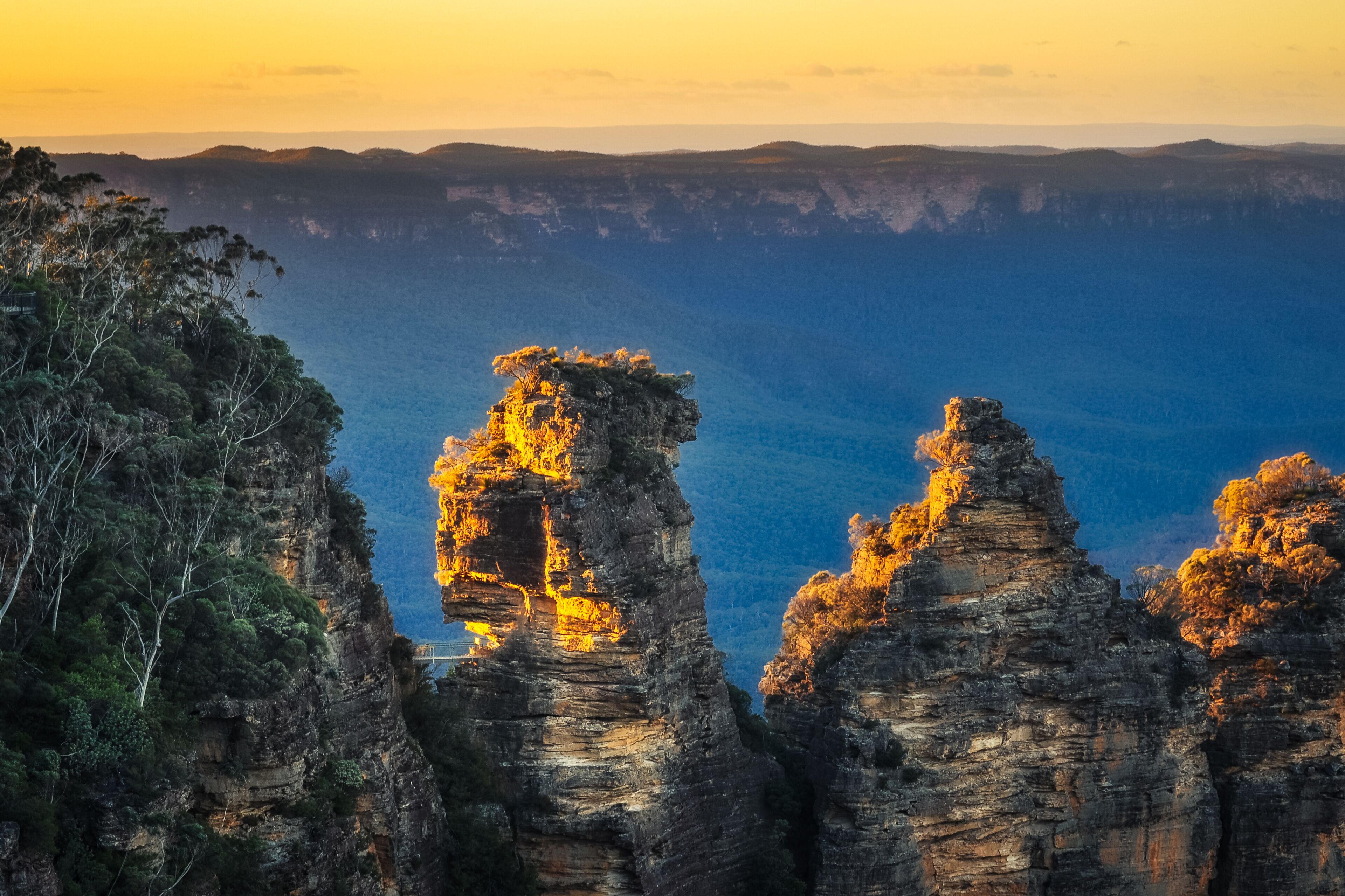 A canyon with prominent rock formations and a sunset.