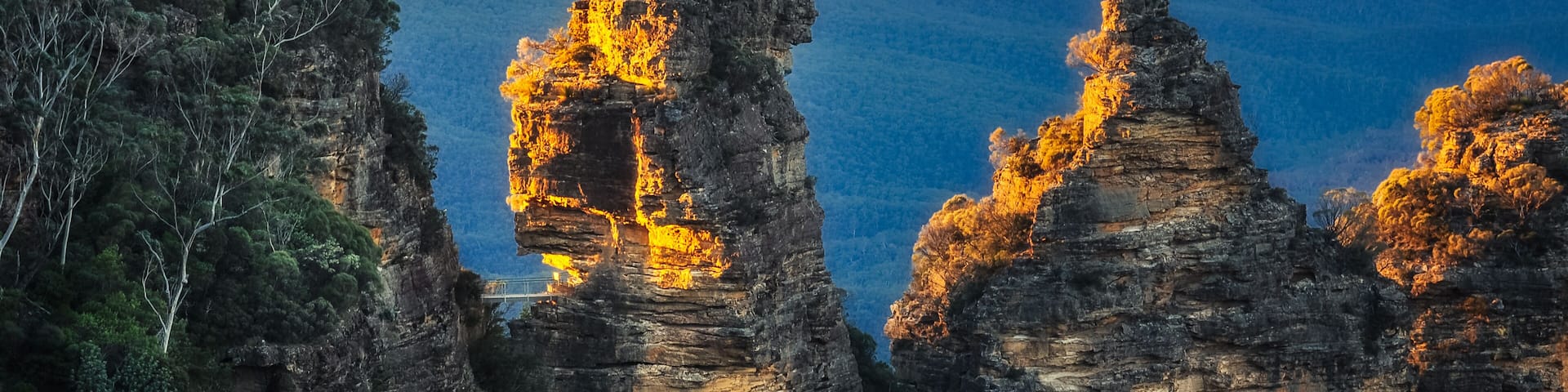 A canyon with prominent rock formations and a sunset.