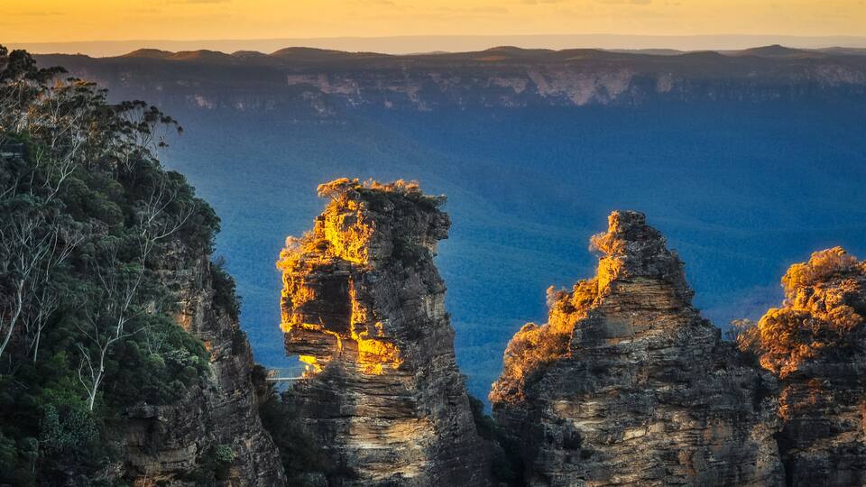 A canyon with prominent rock formations and a sunset.