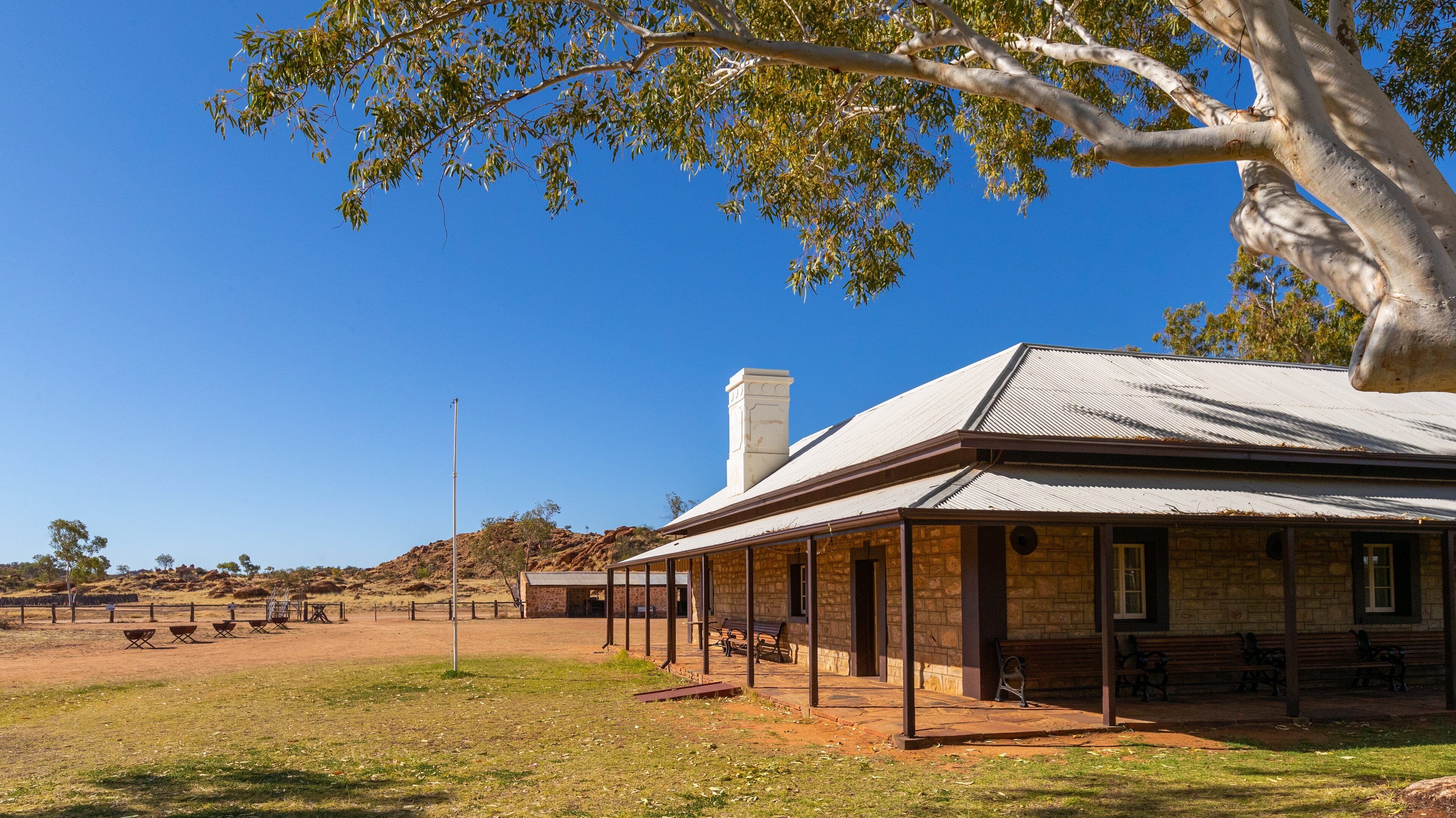 Alice Springs Telegraph Station showing farmland and a small town or village