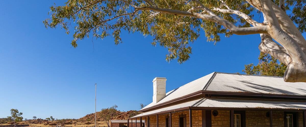 Alice Springs Telegraph Station showing farmland and a small town or village