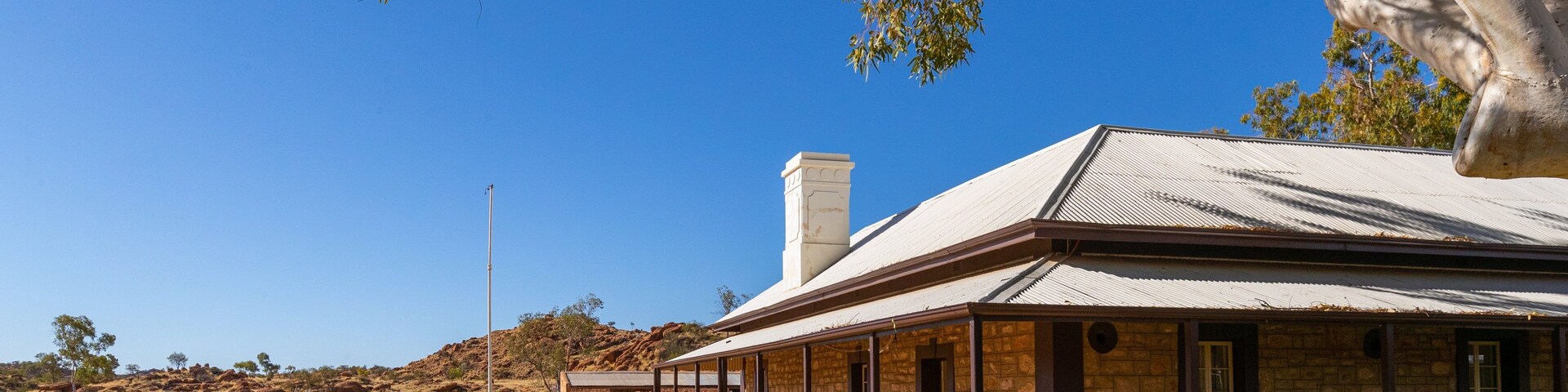 Alice Springs Telegraph Station showing farmland and a small town or village