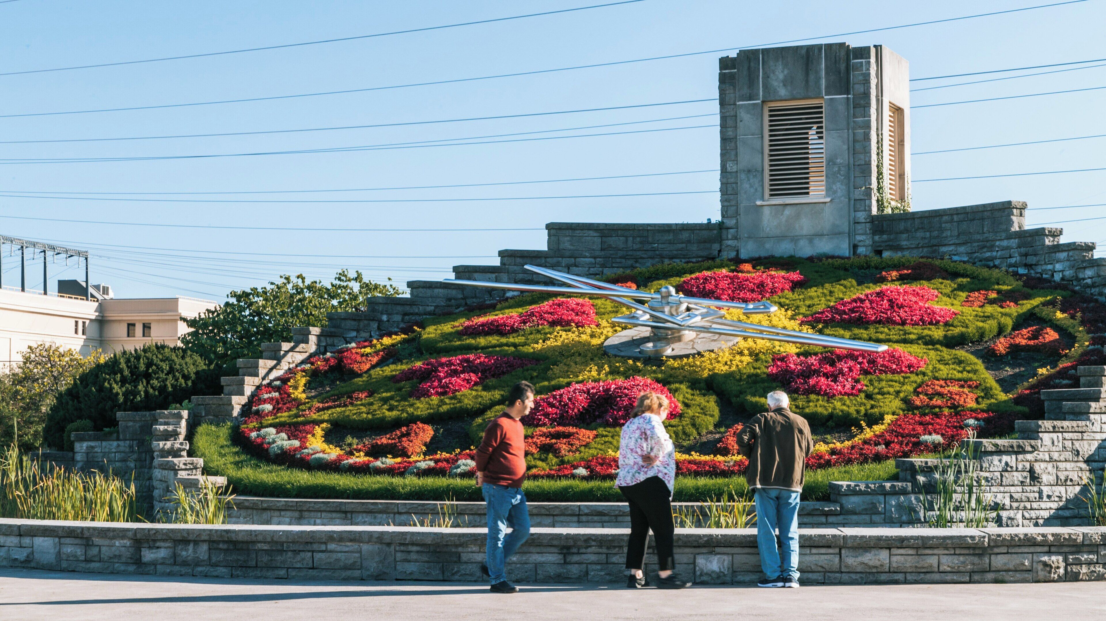 Floral clock displays vibrant flowers at Niagara Falls, Ontario, showcasing nature's beauty and attracting visitors throughout the year