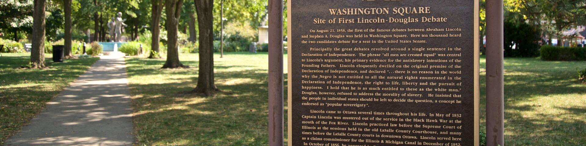 Washington Square Park showing signage and a garden