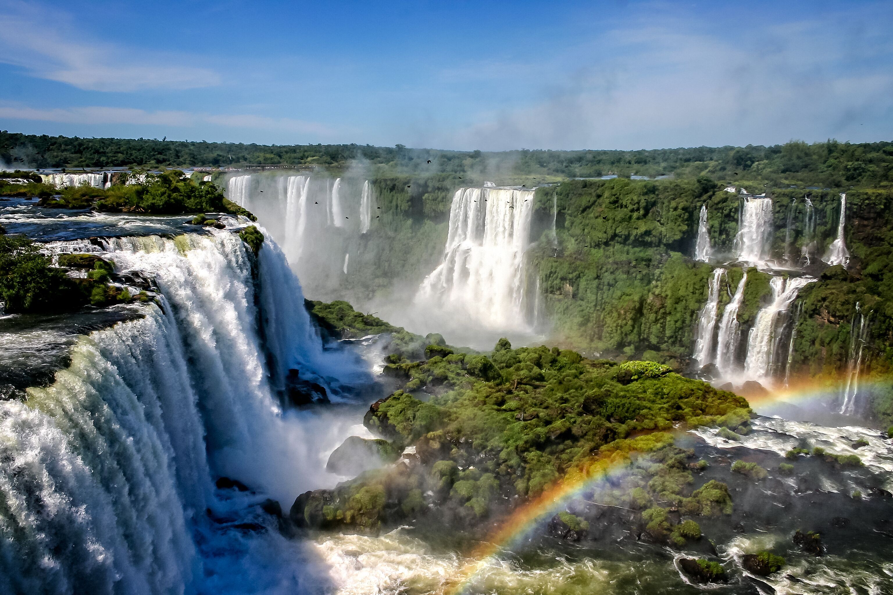 A large waterfall with multiple cascades surrounded by lush greenery.