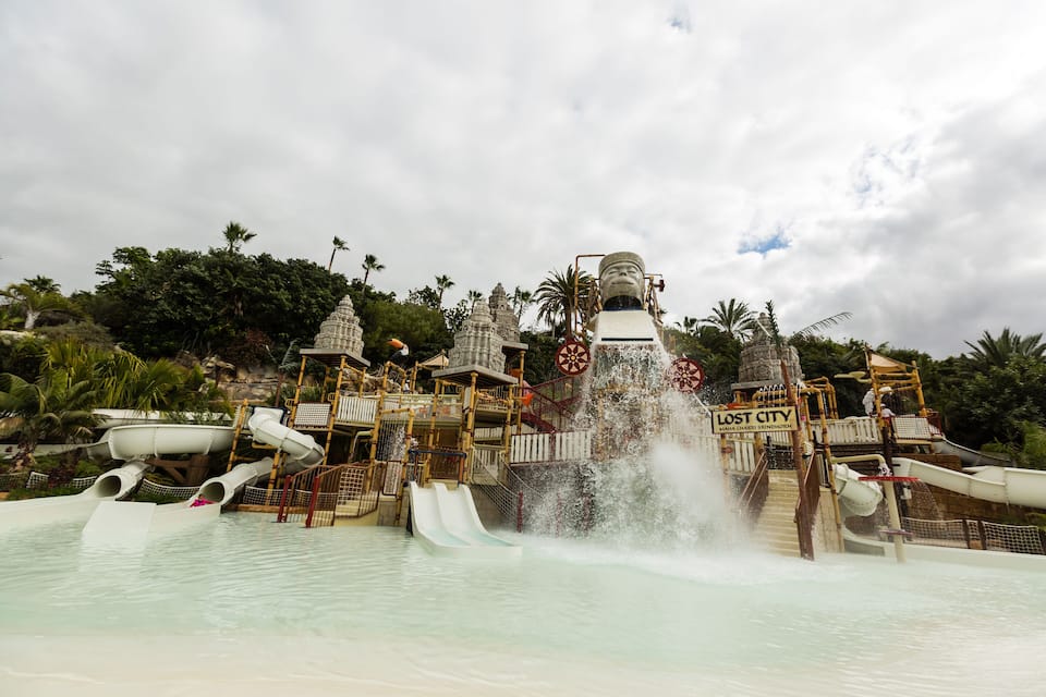 A water park with slides, a water fountain, and a sign that reads "Lost City."