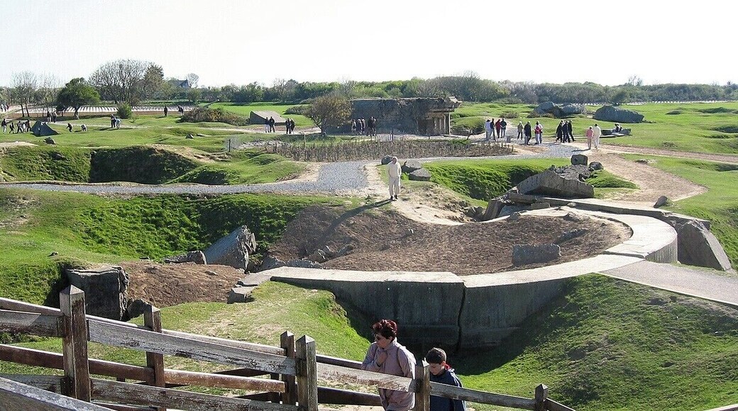 An impressive D-Day site, this strategic bluff overlooking Utah Beach and Omaha Beach was heavily bombed in the weeks and days leading up to the invasion. To get a true appreciation of the effect of this bombing, bring up the map in satellite view!
Although the Germans had initially positioned six large guns here, the aerial bombings forced them to hide the guns, rendering them useless on D-Day. To be certain, though, US Army Rangers assaulted and scaled the cliffs to secure the site.