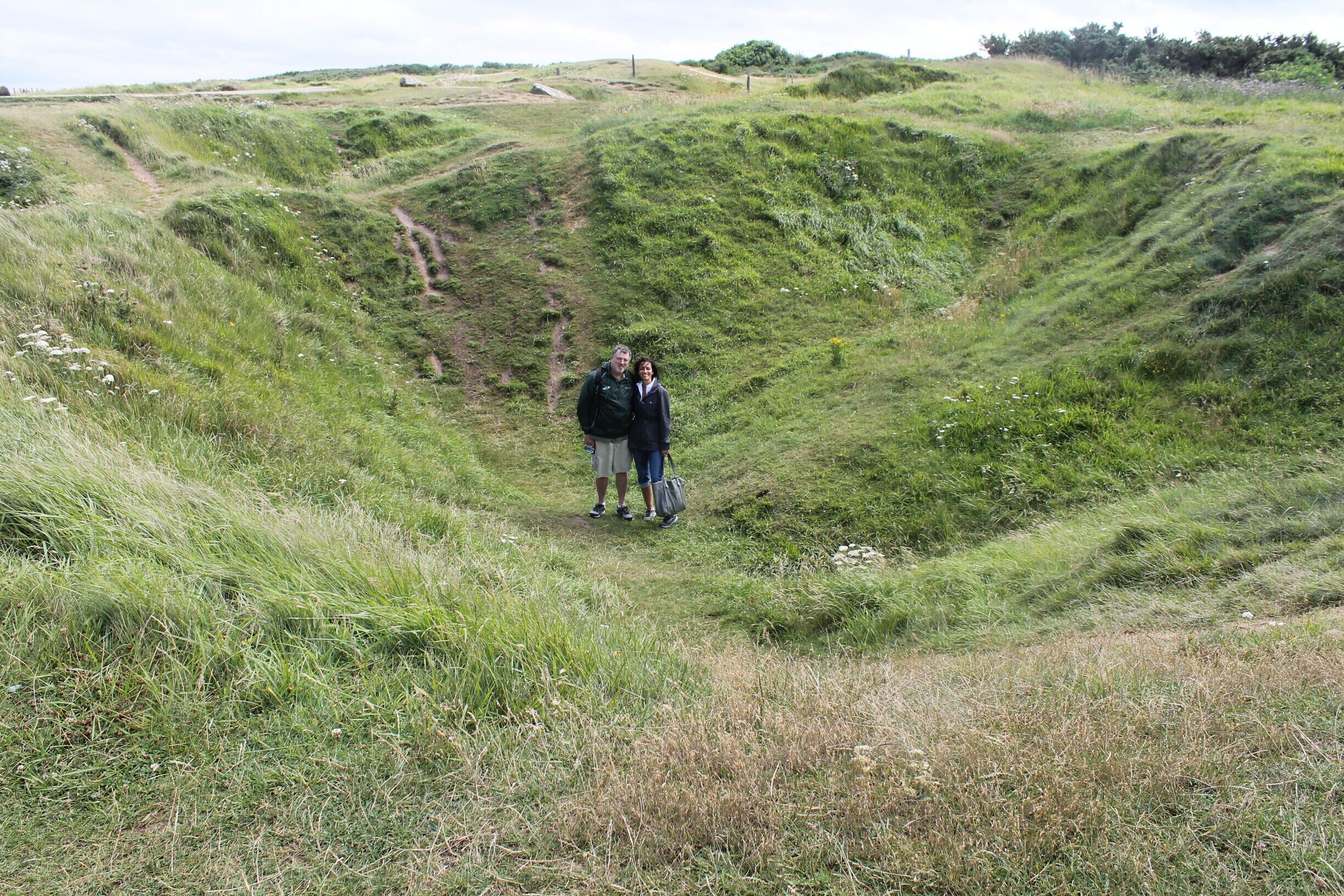 Us in a bomb crater at Pointe du Hoc. The site of an impressive Allied raid during D-day.