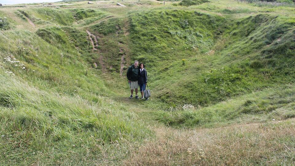 A grassy hill with a dirt path.