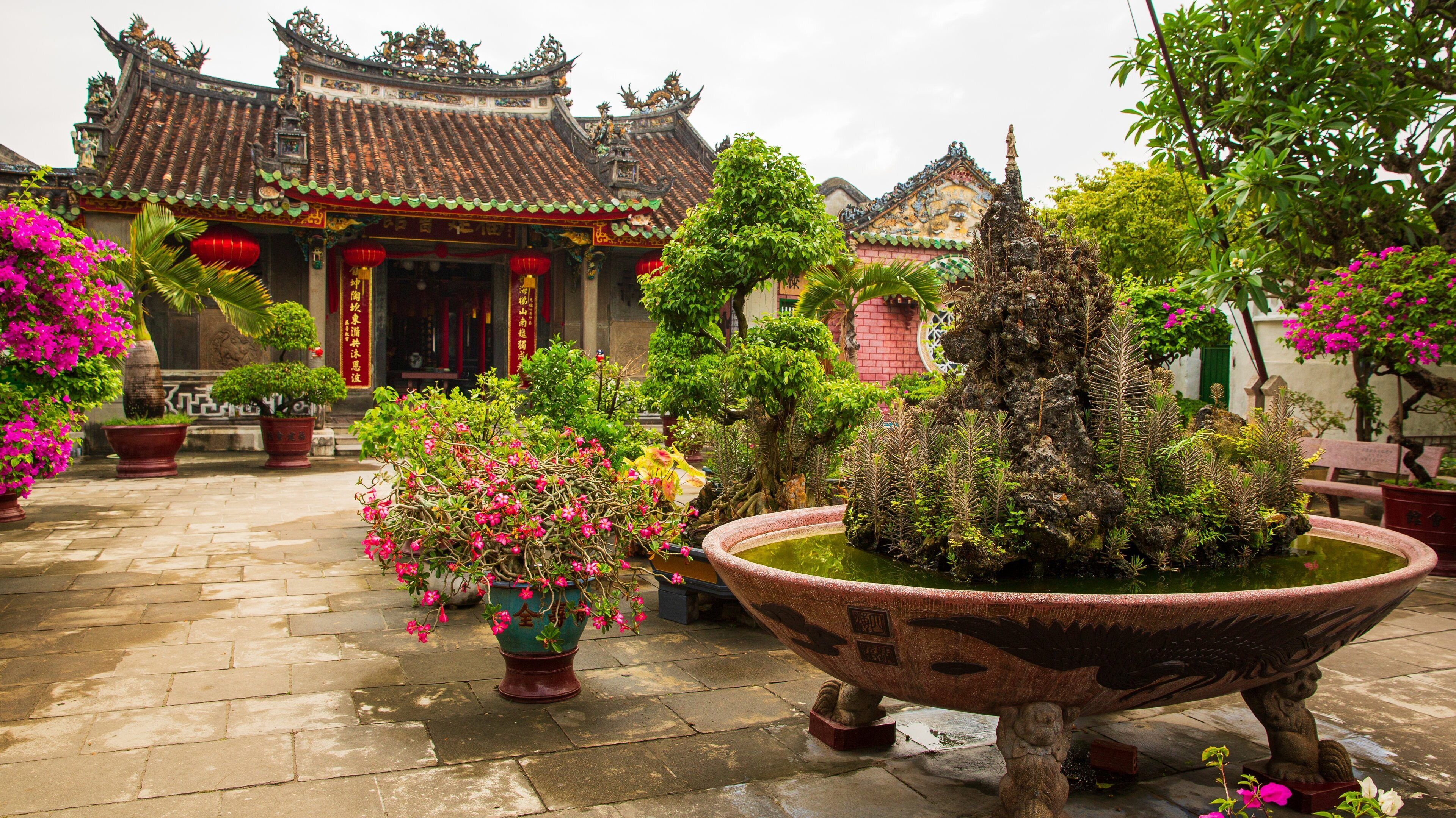 Assembly Hall of the Fujian Chinese Congregation showing heritage elements, flowers and a park