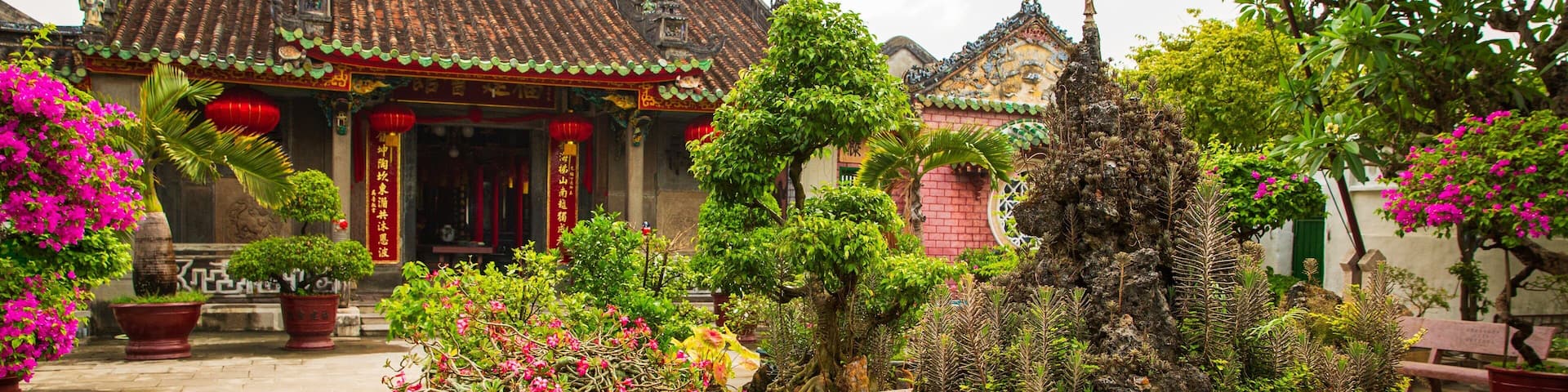 Assembly Hall of the Fujian Chinese Congregation showing heritage elements, flowers and a park