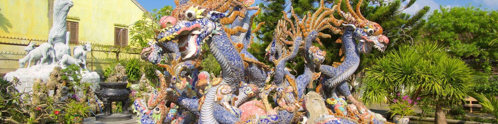 A colorful mosaic fountain with intricate designs and a pond.