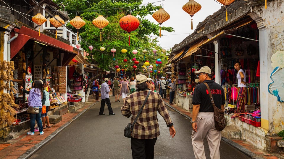 Hoi An Ancient Town featuring street scenes and markets as well as a couple