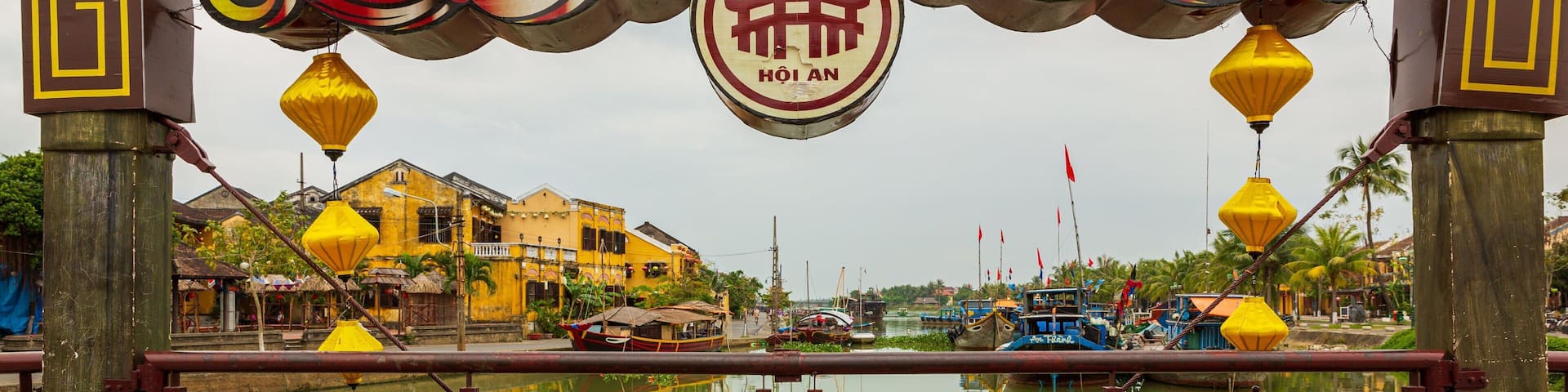 A traditional gate with a dragon design and the word "Hội An" in the center.