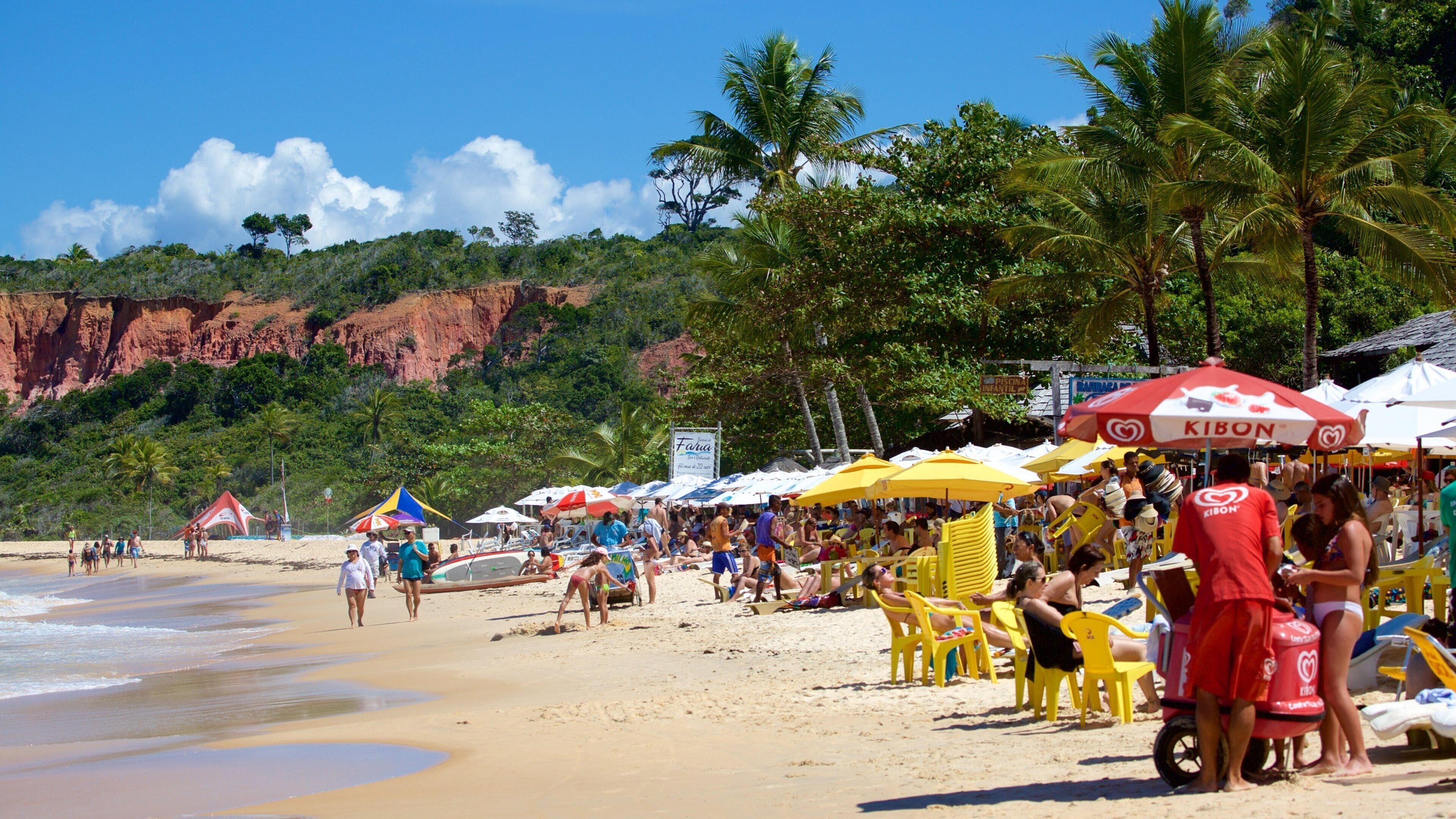 Pitinga Beach which includes a sandy beach, general coastal views and outdoor eating